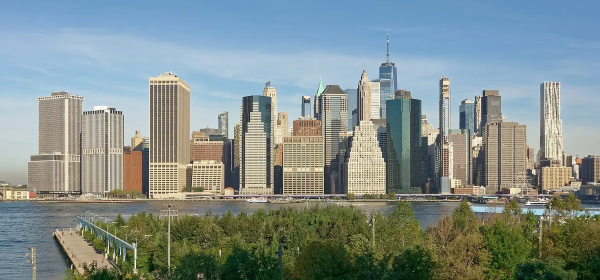 Lower Manhattan's office towers seen across the East River from Brooklyn Bridge Park on a clear morning