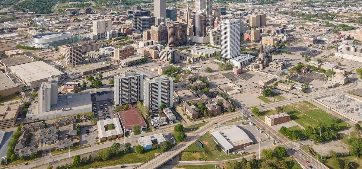 Aerial view of downtown Tulsa's towers and the city grid spreading to the horizon